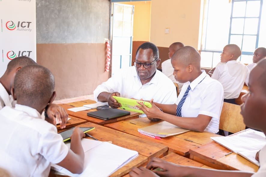 PS Stephen Isaboke, EBS, interacts with students at Kisii Comprehensive School during the second phase of the Digital Literacy Programme