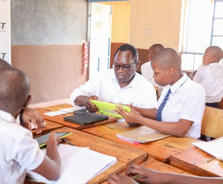 PS Stephen Isaboke, EBS, interacts with students at Kisii Comprehensive School during the second phase of the Digital Literacy Programme